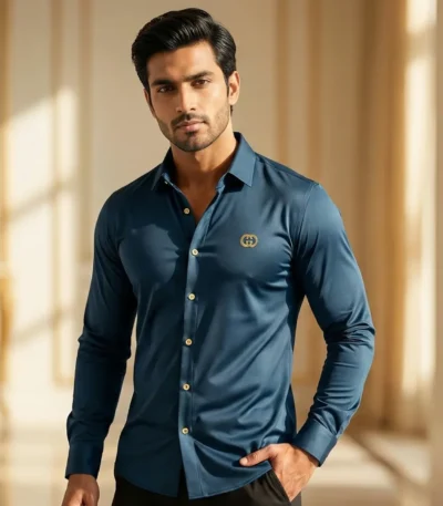 Man wearing a premium teal blue slim fit formal shirt with gold buttons and chest logo.