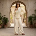 Cream colored women's vintage shirt featuring an intricate floral lace Peter Pan collar and geometric embroidery (1)