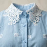Elegant sky blue vintage style women's blouse featuring a white lace Peter Pan collar and embroidered geometric patterns (2)