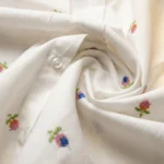 Elegant women's white long sleeve shirt with scattered multicolor floral embroidery and button down front (3)