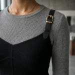 Premium women's layered top featuring a mushroom grey long sleeved base and a black bodice overlay with leather style buckle straps (1)