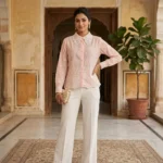 Women in pastel pink full sleeve shirt with white lace Peter Pan collar and geometric square motifs (1)