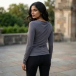 A woman wearing a charcoal grey full sleeves top with a draped neckline (2)