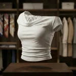 Elegant white off shoulder draped women's top with intricate floral lace back and shoulder detailing (1)