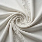 Elegant white off shoulder draped women's top with intricate floral lace back and shoulder detailing (4)