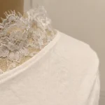 Elegant women’s off shoulder white top featuring intricate lace trim neckline and long sleeves (6)