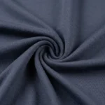 Front and back view of a woman wearing a charcoal grey full sleeve cowl neck top with blue jeans (4)