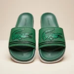 Front view of Lacoste green slides with oversized crocodile logo and white sole (1)