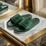 Front view of Lacoste green slides with oversized crocodile logo and white sole (2)