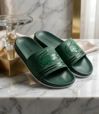 Front view of Lacoste green slides with oversized crocodile logo and white sole (3)