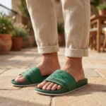 Front view of Lacoste green slides with oversized crocodile logo and white sole (4)
