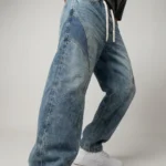 Light blue acid wash baggy jogger jeans with dark blue side panels and white drawstrings (1)