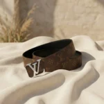 Louis Vuitton women's reversible monogram belt with silver LV initiales buckle on a stone pedestal (4)