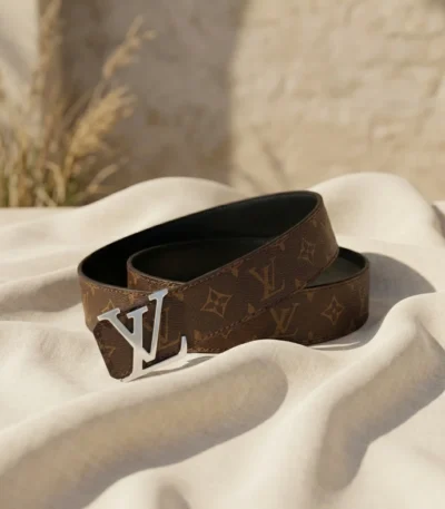 Louis Vuitton women's reversible monogram belt with silver LV initiales buckle on a stone pedestal (4)