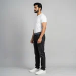 Men's dark wash slim fit indigo denim jeans with khaki webbed belt and white sneakers (3)