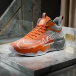 Men's high top basketball shoes in vibrant orange and silver grey with wavy traction sole (2)