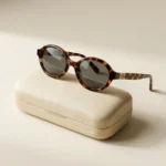 Miu Miu luxury oval tortoise shell sunglasses for women with gold logo temple detail (2)