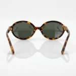 Miu Miu luxury oval tortoise shell sunglasses for women with gold logo temple detail (3)