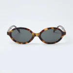 Miu Miu luxury oval tortoise shell sunglasses for women with gold logo temple detail (6)