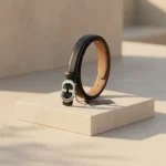 Slim black women's belt with a silver oval monogram buckle (3)