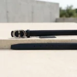 Slim black women's belt with a silver oval monogram buckle (4)