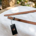 Slim black women's belt with a silver oval monogram buckle (5)