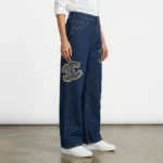 Woman wearing Chanel high waisted wide leg indigo denim jeans with pearl CC logo embellishments (6)