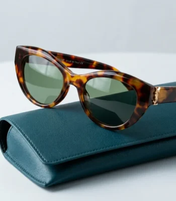 Woman wearing Saint Laurent tortoiseshell cat eye sunglasses with gold YSL logo on temple (4)