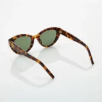 Woman wearing Saint Laurent tortoiseshell cat eye sunglasses with gold YSL logo on temple (6)