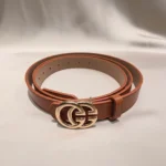 Women wearing a tan leather belt with a gold interlocking buckle on grey formal trousers (1)