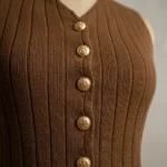 Women's chocolate brown ribbed co ord set featuring a sleeveless V neck vest with gold crest buttons and high waisted wide leg trousers (3)