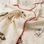 Women’s cream colored notched collar pajama set with whimsical animal print and red piping details (2)