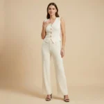 Women's ivory ribbed knit co ord set featuring a V neck sleeveless waistcoat with embossed gold buttons and matching wide leg trousers (2)