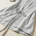 Women's light grey heathered t shirt featuring a delicate white floral lace open back with tie up detail (3)
