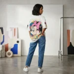 Women's oversized white t shirt featuring a retro Minnie Mouse graphic print with pink bow and leopard accents (2)