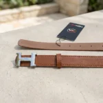 Women's tan leather fashion belt featuring a polished silver H style buckle (1)