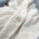 Women's two piece ensemble featuring a sheer white embroidered shirt and a blue denim style vest with golden floral motifs and crochet borders (5)