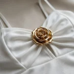 Women's white sweetheart neck camisole top with a central 3D gold rose embellishment and adjustable straps (7)