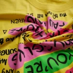 Women's yellow oversized t shirt featuring a pink sequin bunny and rhinestone text embellishments (3)
