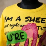 Women's yellow oversized t shirt featuring a pink sequin bunny and rhinestone text embellishments (4)