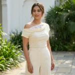 a cream colored asymmetrical off shoulder top with white lace detailing (2)