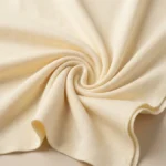 a cream colored asymmetrical off shoulder top with white lace detailing (3)