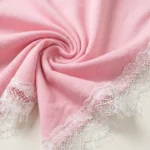 a pink crew neck top with white lace sleeves and V shaped white lace back panel.(1)