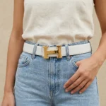 a white textured leather belt with a gold H shaped buckle (3)