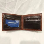 Dark brown Bomshisky men's bifold wallet featuring an embossed B pattern and contrast orange stitching (4)