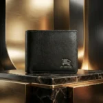 Front and interior view of Burberry men's black textured leather bifold wallet with embossed logo (2)