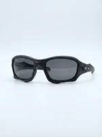Oakley men's matte black rectangular sports sunglasses with dark grey lenses on a leather case (3)