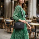 Prada women's black pebbled leather camera bag with wide logo print crossbody strap and silver hardware (1)