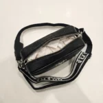 Prada women's black pebbled leather camera bag with wide logo print crossbody strap and silver hardware (3)