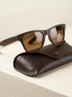 Ray Ban men's matte brown wayfarer sunglasses with brown polarized lenses shown from side and front angles (1)